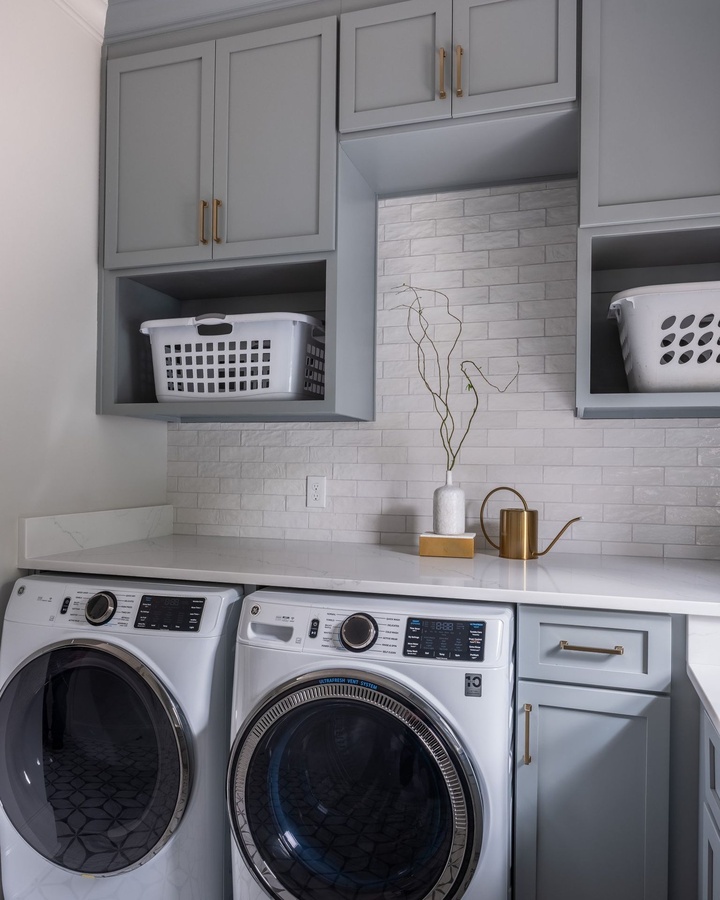 Blue shaker laundry cabinetry by Designer Cabinets