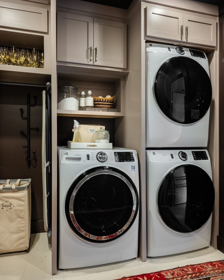 Greige shaker laundry cabinetry by Designer Cabinets