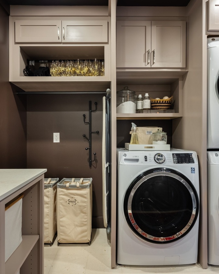 Greige shaker laundry cabinetry by Designer Cabinets